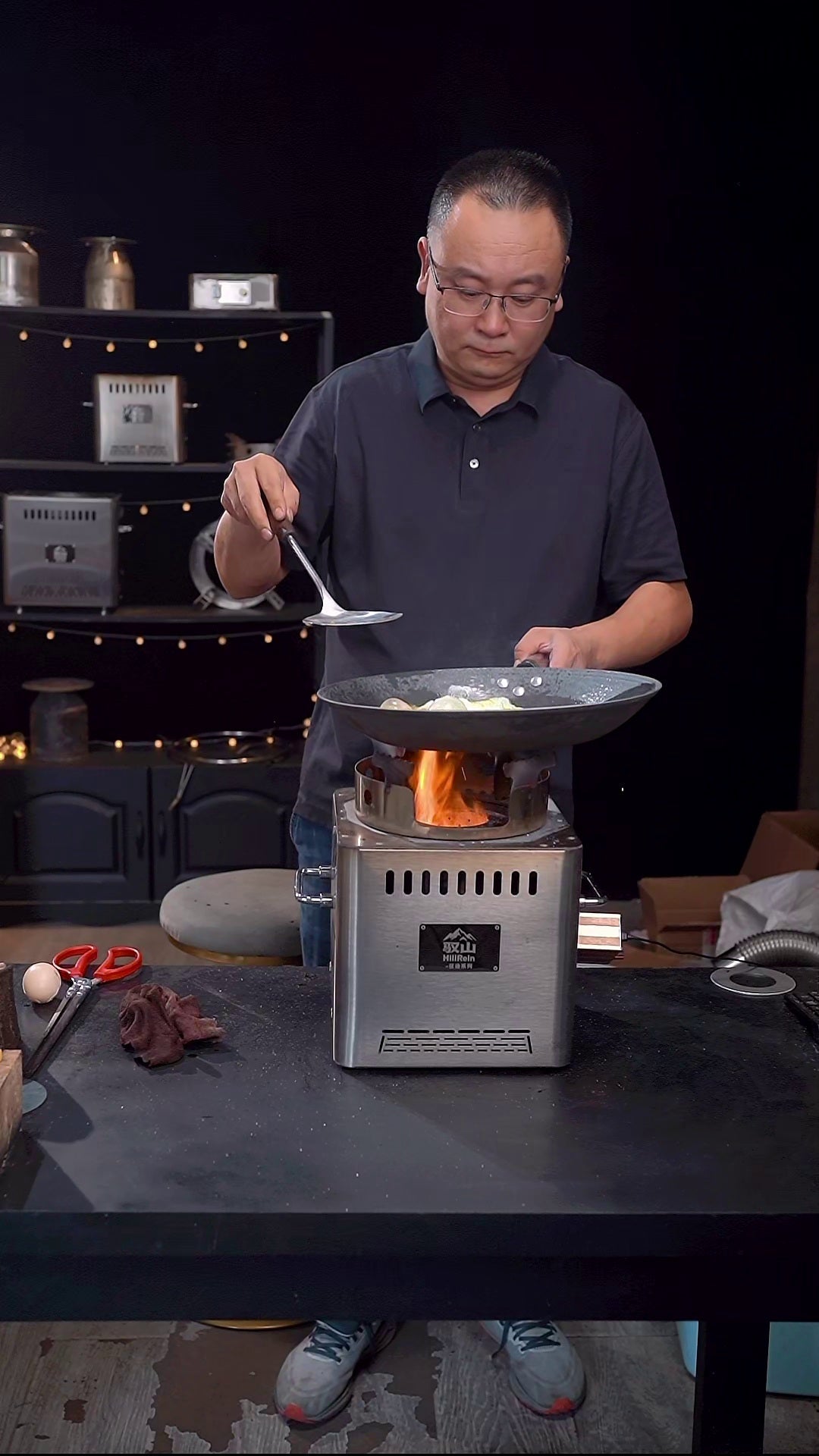 Hillrein outdoor wood cooking stove making a real wok dinner with small dry wood pieces and steady flame control