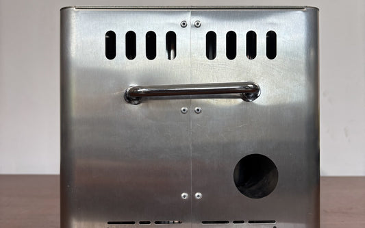 Hillrein wood gasifier stove airflow image showing the Zhengtu side vent openings and fan-side intake area kept clear on a tabletop