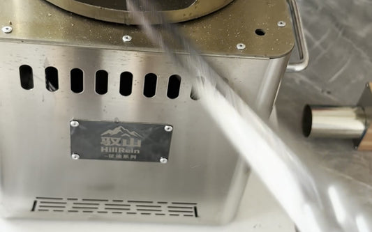 Hillrein cooking with small wood image showing a dry 10 cm piece being fed into the Zhengtu stove from a sorted cooking-fuel pile