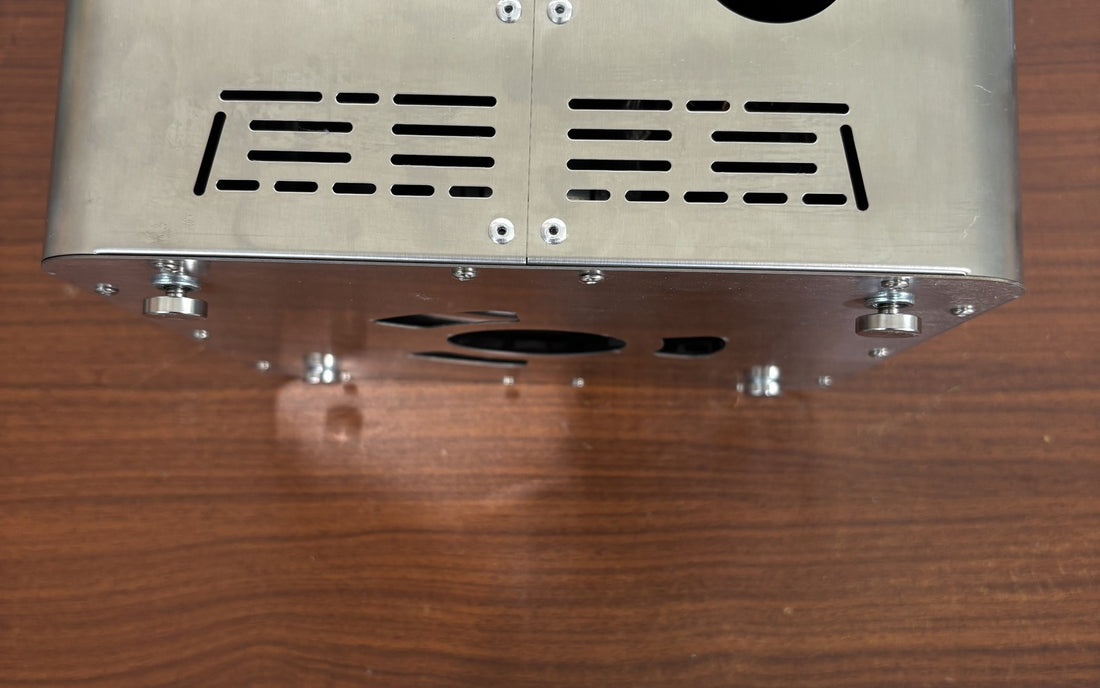 Hillrein Zhengtu outdoor wood cooking stove underside showing four metal feet and lower ventilation openings during a cold stability inspection