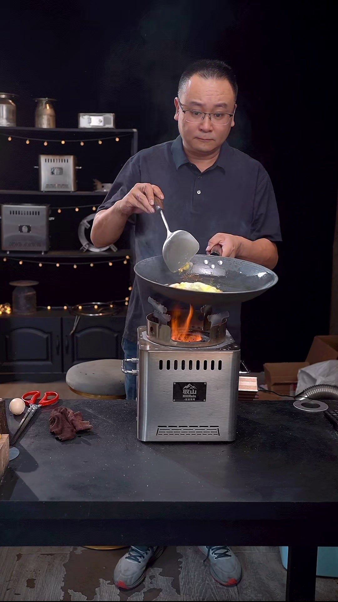 Hillrein wood stove for cooking a real wok meal with fan-assisted heat and low-smoke flame after stabilization