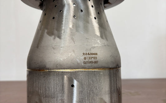 Hillrein 304 stainless steel wood stove image showing the Zhengtu inner chamber surface and stamped 304 detail after real heat use, before any hard ash scraping
