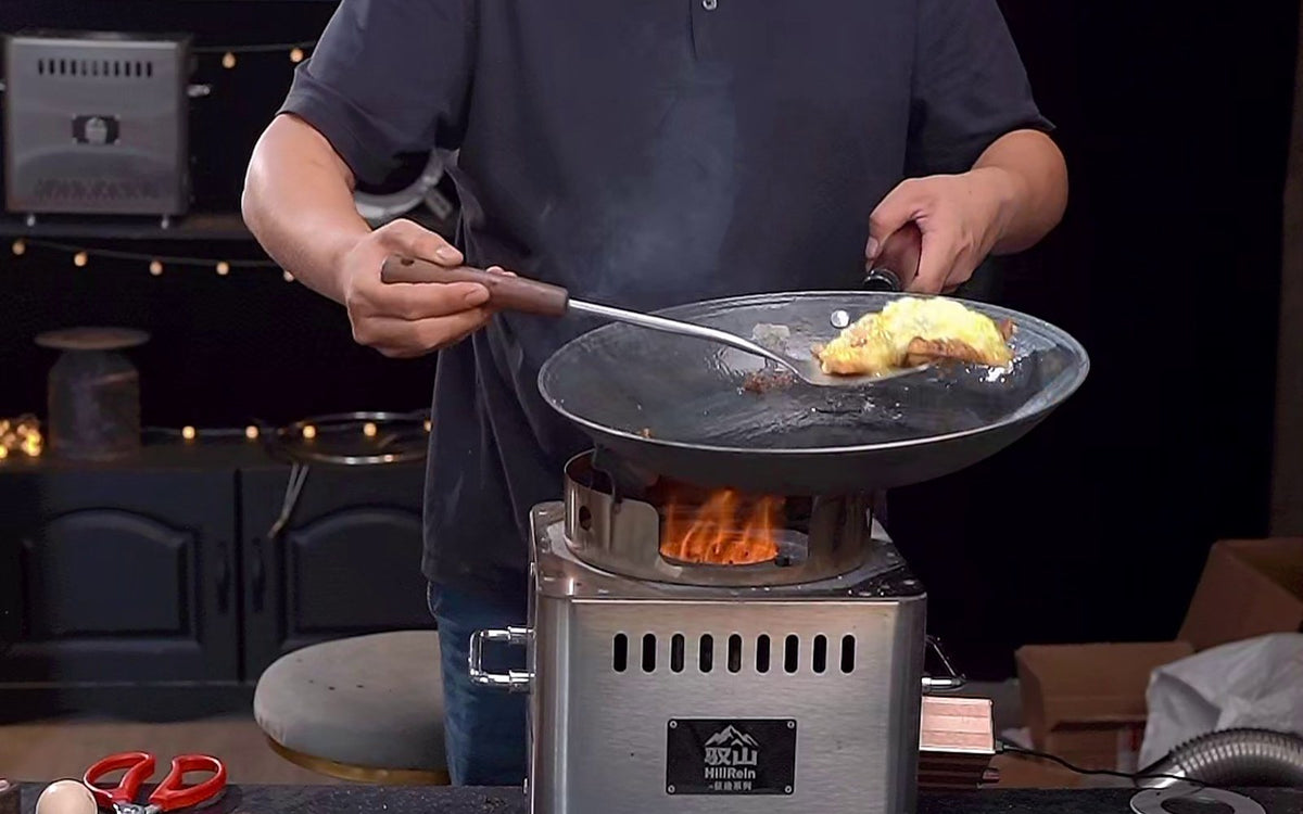 Hillrein Zhengtu wood stove fire control example with a cook holding a frying pan and lifting cooked egg with a spatula above the flame